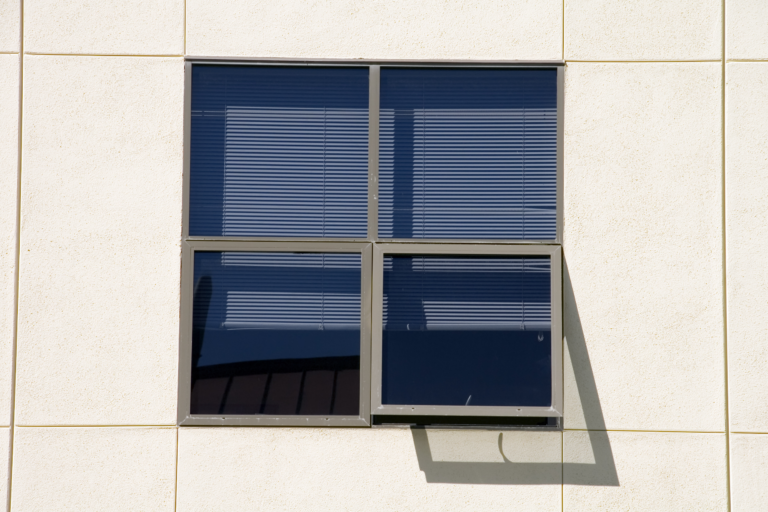Aluminium Window with a dark shadow that is projecting onto the building