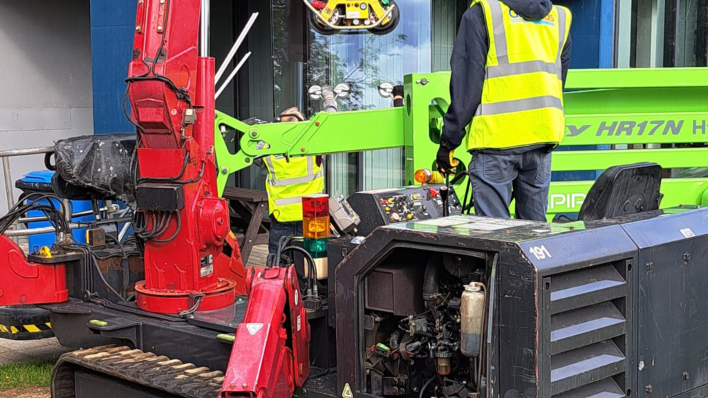 GlassPlus team using specialist lifting equipment for glazing replacement at Longsands Academy