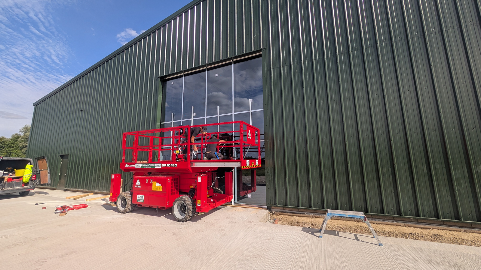 GlassPlus team installing curtain wall glazing for Burlton A P Ltd in Royston using a scissor lift